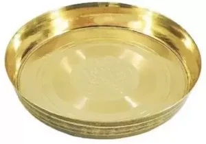 Introducing our exquisite Pure Heavy Brass Thali for Pooja Half Plate, a perfect addition to your sacred rituals and ceremonies. Crafted with utmost precision and dedication, this thali embodies the essence of tradition and elegance. Made from high-quality brass, this thali exudes a captivating aura that enhances the spiritual ambience of any pooja or worship setting. The heavy brass material ensures durability, promising longevity for generations to come. Its lustrous finish adds a touch of sophistication, making it an ideal choice for both religious occasions and decorative purposes. The half plate design is thoughtfully crafted to accommodate various offerings and prasad during poojas. With its ample space, you can arrange flowers, incense sticks, diyas, and other sacred items neatly, creating an aesthetically pleasing arrangement that will leave a lasting impression on all attendees. The intricate detailing on the surface of the thali reflects the skilled craftsmanship involved in its creation. Delicate patterns and motifs adorn the brass, showcasing the rich cultural heritage and artistic finesse. Each stroke tells a story, adding depth and meaning to your religious practices. Designed to be practical and user-friendly, this brass thali is easy to clean and maintain. Simply wipe it with a soft cloth to retain its natural shine and beauty. Its sturdy construction ensures stability, allowing you to focus on the spiritual aspects of the occasion without worrying about any mishaps. Whether you're performing daily prayers, hosting religious gatherings, or presenting it as a thoughtful gift, our Pure Heavy Brass Thali for Pooja Half Plate is sure to impress. Immerse yourself in the divine energy it emanates, creating a serene atmosphere that fosters devotion and tranquility. Pure Heavy Brass Thali
